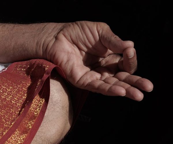 Close up of hands in a mudra position during yoga.
